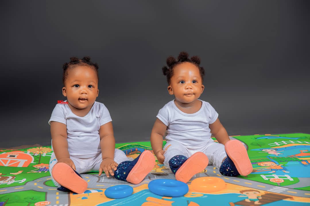 Happy IVF twins sitting together born at Lusaka fertility clinic (privacy protected)